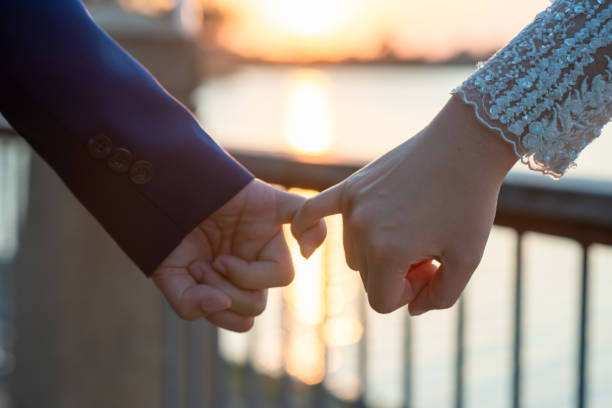 istock Women and men hold hands in the evening 1215569955