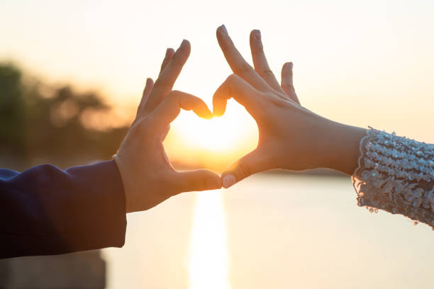 istock Women and men hold hands in the evening 1215569982