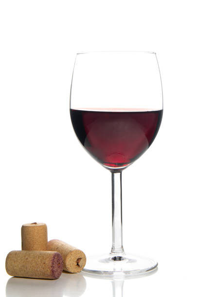 istock red wine glass and corks on white background 1215570146