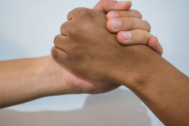 istock Handshake between black woman and white man 1215571142