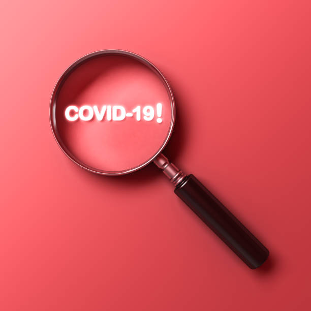 istock Magnifying glass with neon light covid-19 text isolated on red pastel color background 1215573854