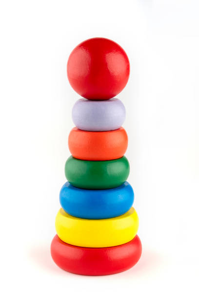istock Final Touch To Achievement, toy blocks pyramid, multicolor wooden ring stack isolated white background 1215575161