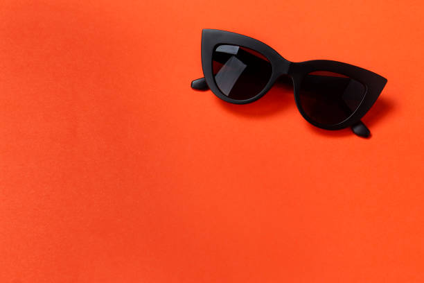 istock Fashionable sunglasses on an orange background. 1215575506
