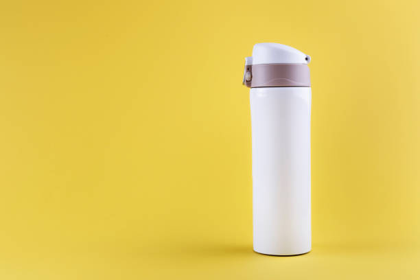istock white thermos for travel, on a yellow background. 1215575581