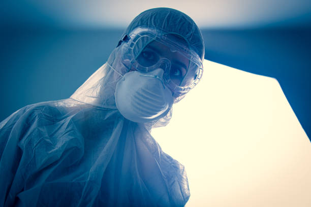 istock Doctor in protection clothes in laboratory with light on background 1215577026