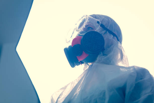 istock Doctor in protection clothes in laboratory with light on background 1215577045