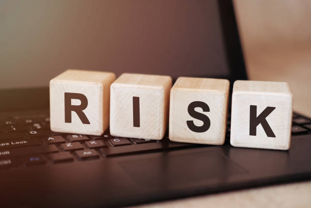 istock RISK concept on wooden cubes on a black tablet 1215577965