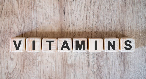 istock VITAMINS text word on wooden cubes on wooden background 1215577970