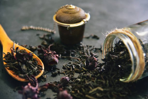 Aroma Herbal Tea Leaves. Tea ceremony, tea leaves in a jar, a wooden spoon and a net for brewing tea. stock photo