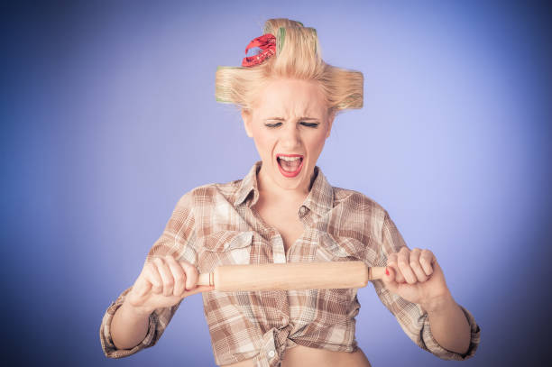 istock Pin up young housewife with rolling pin 1215582421