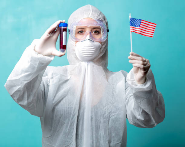 istock scientist medic with American flag and vaccine flask 1215583500