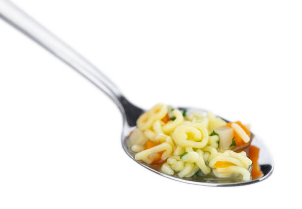 istock Alphabet Soup (selective focus) isolated on white background 1215586164