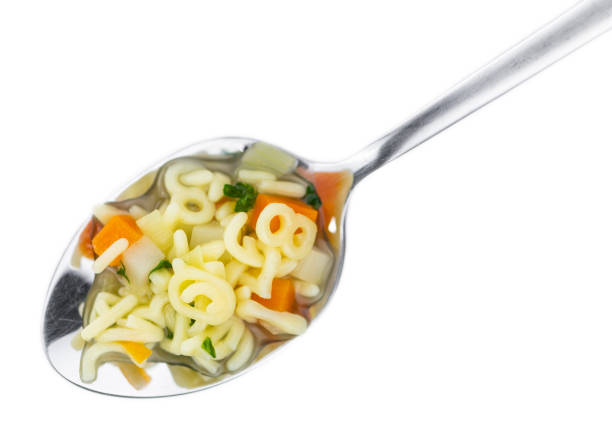 istock Alphabet Soup (selective focus) isolated on white background 1215586184
