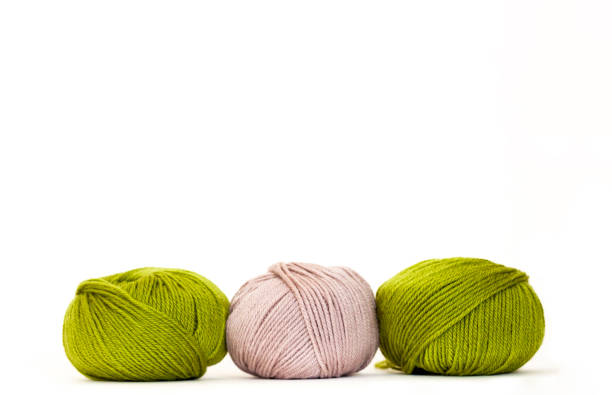 istock Three balls of wool, white bcakground with copy space 1215587278