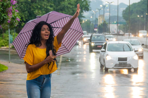 istock Black young woman calling a taxi 1215587442