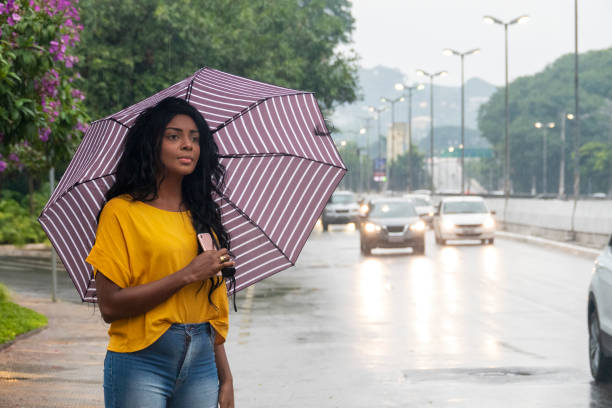 istock Black young woman calling a taxi 1215587459