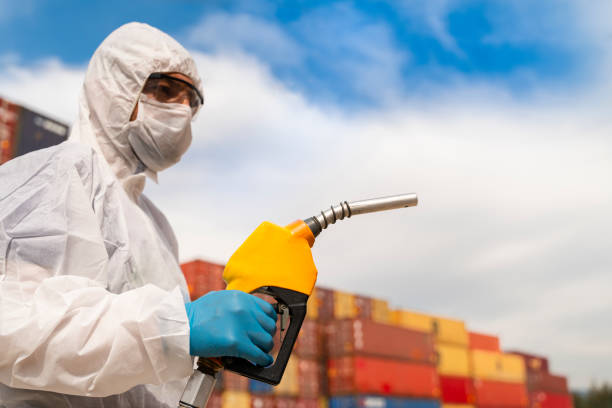 istock A man with protective suits while refueling the vehicle. 1215588891
