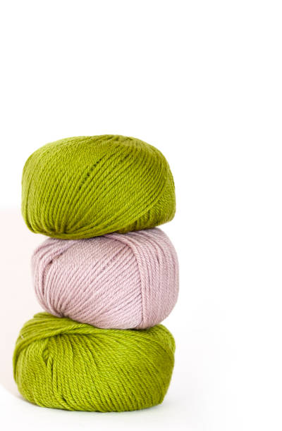 istock Three balls of wool, white bcakground with copy space 1215590576