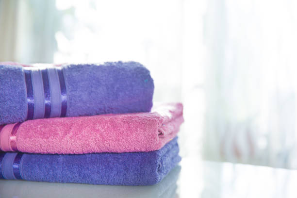 istock folded purple and pink towels on a light background 1215590849