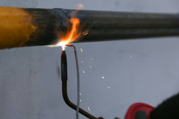 istock gas welding metal pipe by gas burner 1215590859