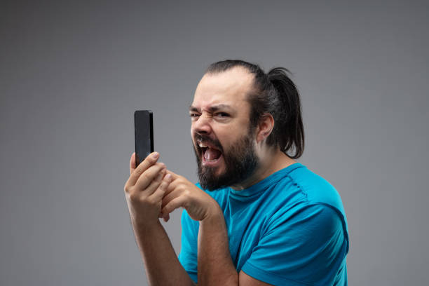 hombre con teléfono inteligente quejándose o gritando - complaining whining no easel fotografías e imágenes de stock