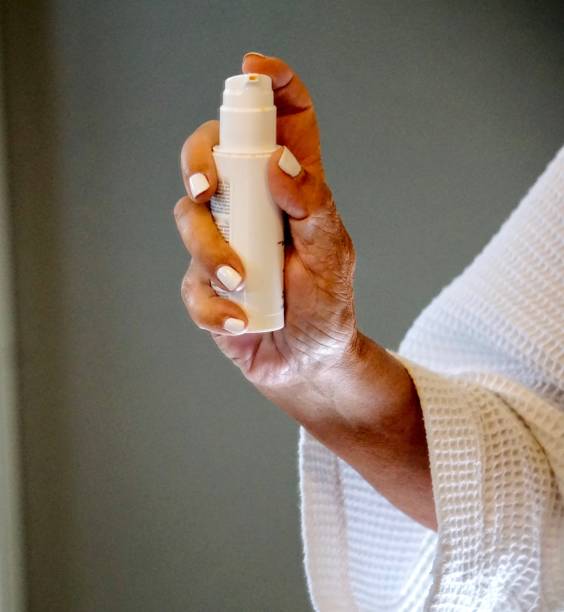 istock woman's hand holding beauty product 1215595606