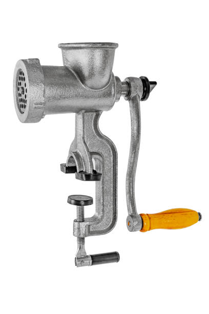 Manual meat grinder which is prepared minced for meatballs. It is mounted on the edge of the kitchen table with a clamping screw.