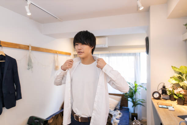 istock Young man wearing shirts in the morning 1215597853