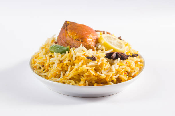 Delicious spicy chicken biryani in traditional bowl on White background, Indian or Pakistani famous masala rice food. Potato and meat are main ingredients of this recipe | Best Ramadan iftar meal.