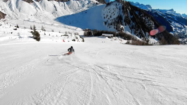 Active man enjoying a sunny day on ski slopes