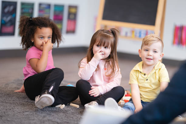istock Happy preschool students in classroom 1215601493