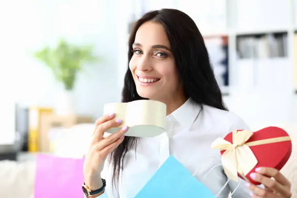 Photo of Smiling girl rejoicing gift opened heart with bow