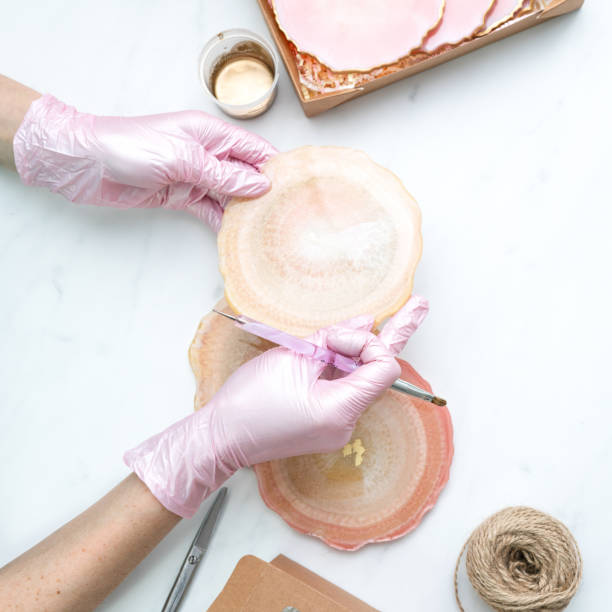 istock Creativity and craft. A young girl creates coasters from resin. Gift wrapping. Decorative packaging. Idea for business. Remote work, work at home. Art coasters. 1215602503