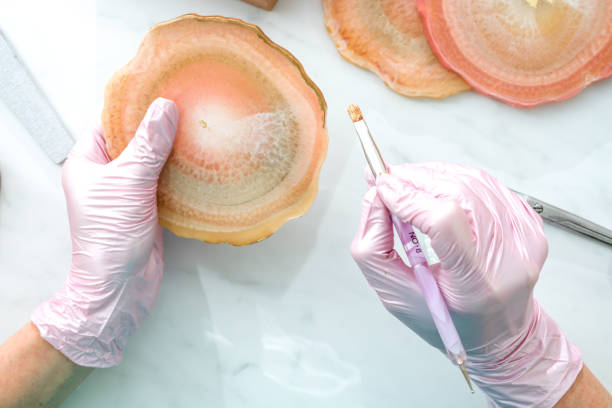 istock Creativity and craft. A young girl creates coasters from resin. Gift wrapping. Decorative packaging. Idea for business. Remote work, work at home. Art coasters. 1215602516