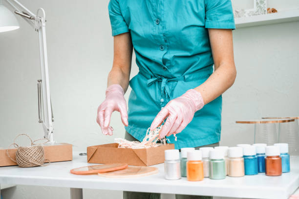 istock Creativity and craft. A young girl creates coasters from resin. Gift wrapping. Decorative packaging. Idea for business. Remote work, work at home. Art coasters. 1215602521