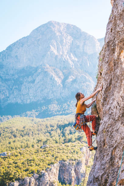 istock Girl climbs a rock. 1215602684