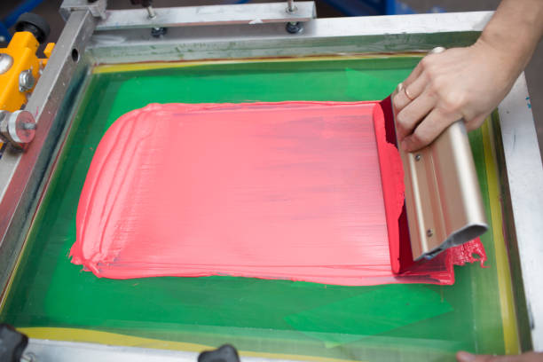istock Silk screen printing. Serigraphy. Color paints and fabric. Plastisol paint and squeegee. 1215606010