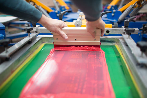 istock Silk screen printing. Serigraphy. Color paints and fabric. Plastisol paint and squeegee. 1215606024