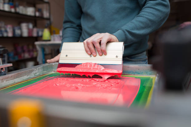 istock Silk screen printing. Serigraphy. Color paints and fabric. Plastisol paint and squeegee. 1215606026