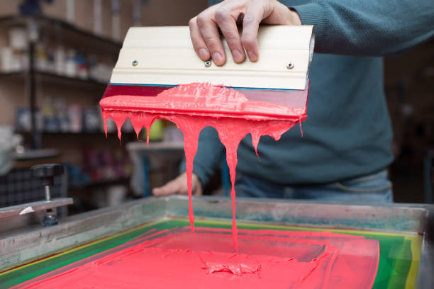 istock Silk screen printing. Serigraphy. Color paints and fabric. Plastisol paint and squeegee. 1215606031