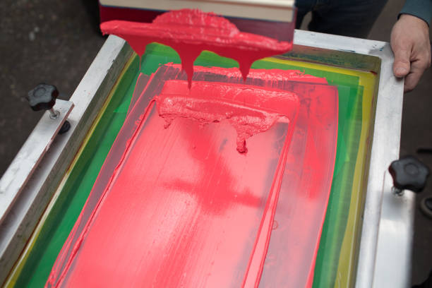 istock Silk screen printing. Serigraphy. Color paints and fabric. Plastisol paint and squeegee. 1215606036