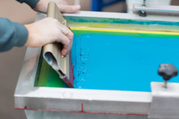 istock Silk screen printing. Serigraphy. Color paints and fabric. Plastisol paint and squeegee. 1215606043