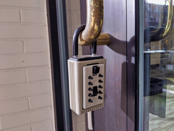 real estate key lock box on the entrance to a business for sale Close up of a real estate key lock box on the entrance to a business for sale key package stock pictures, royalty-free photos & images