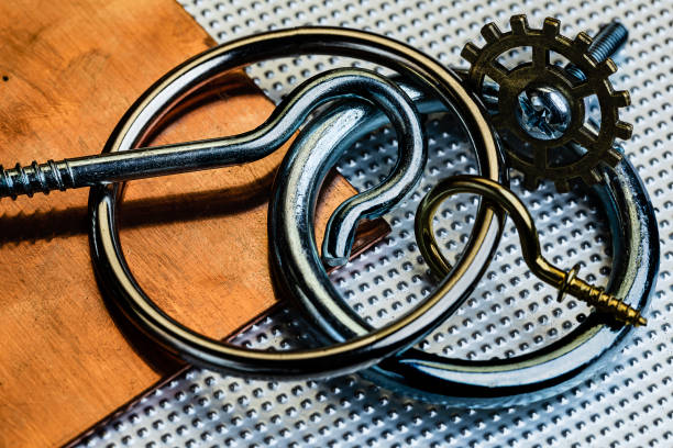 istock An oxidized and used copper and Stainless steel surface with several stainless steel rings and screw hooks, a brass screw hook and a brass gear.  Industrial macro setting.  Some room for copy writing. 1215612212