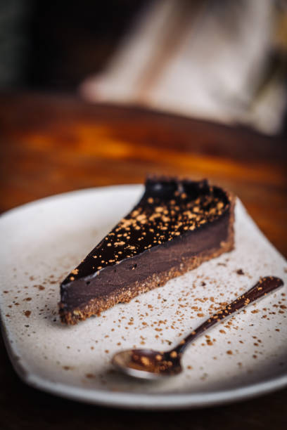 istock Slice of raw vegan dark chocolate cake 1215616252