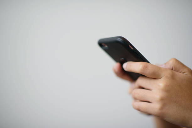 istock close up hand typing smartphone with copy space for text, shopping online, sending email, use smartphone, mobile phone, telephone 1215620252