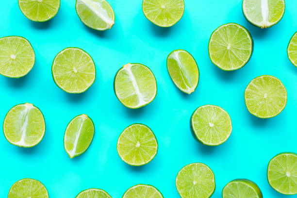 istock Fresh limes on blue background. top view 1215624804