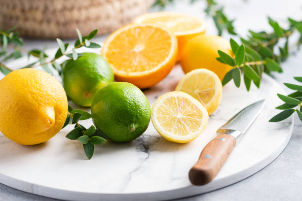 Citrus fruits on marble cutting board