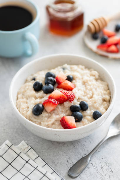 istock Oatmeal with strawberries and blueberries 1215625099