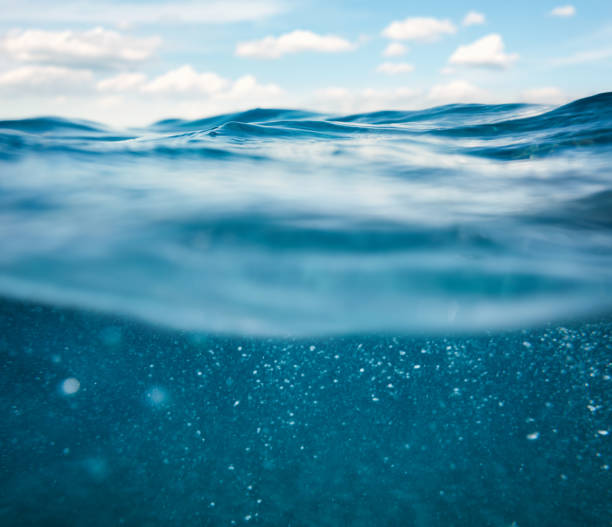 Undersea View Sea waves with idyllic blue sky (combined underwater and surface view). standing water photos stock pictures, royalty-free photos & images